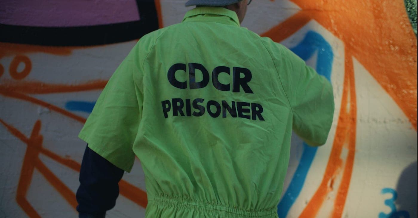 Person wearing a CDCR prisoner jacket